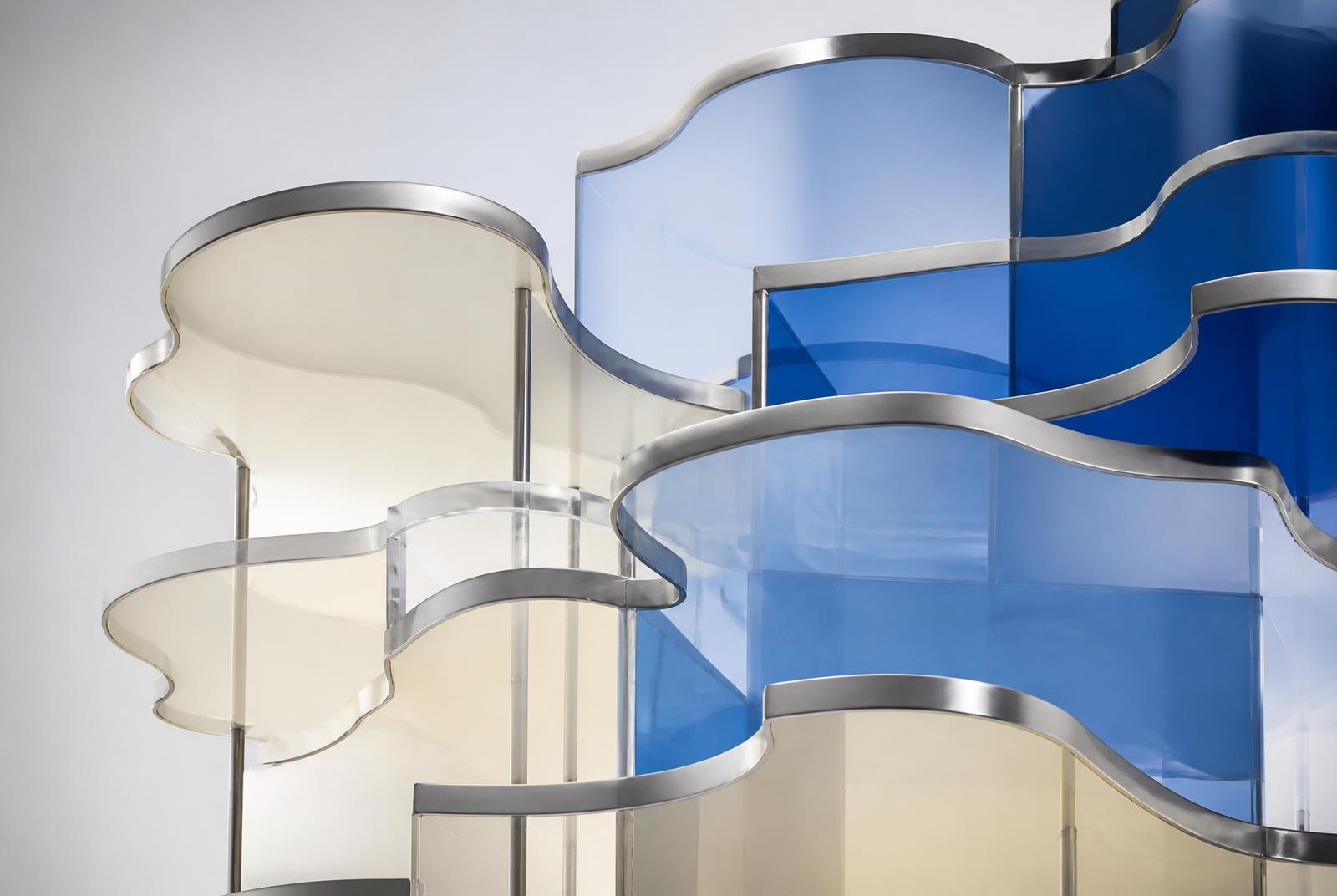 Abstract sculpture of layered translucent ivory and cobalt blue glass panels with brushed metal edges